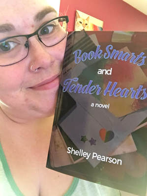 Shelley Pearson with a copy of Book Smarts and Tender Hearts